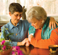 Vision 2014 Dowling 1 Our service is our prayer Sister Anne Maureen Doherty, C.B.S. comforts a woman after the death of a family member.