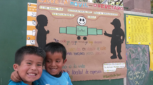 Vision 2017 Scheiber 1 Street-wise sisters on a roll Two children have big smiles at Escuela Móvil.