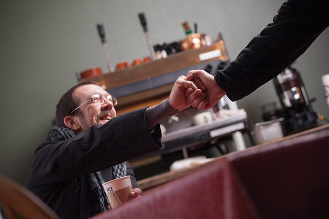 Vision 2018 Langlois 8 Hard road to the monastery Love greets a friend at the monastery’s bookstore and cafe.