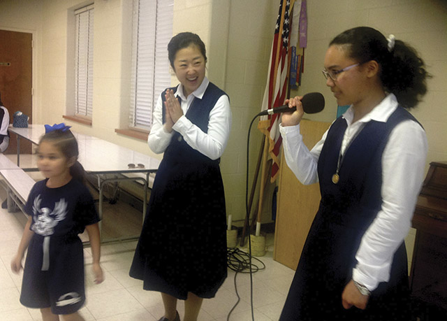 Vision 2018 Lee 2 Lights, camera—convent! Lee with a student and a sister during a school presentation.