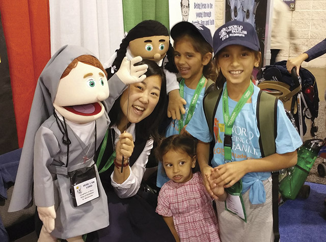 Vision 2018 Lee 3 Lights, camera—convent! Lee has fun with puppets and children at a Salesian Sisters outreach display.