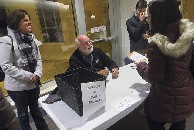 Vision 2018 Scheiber 3 Tendering God on tough streets Boyle signs his book, Tattoos on the Heart(Free Press, 2010), after his talk in Toledo, Ohio.