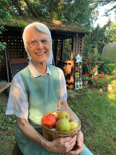Vision 2020 online only Cole 1 Franciscan spirituality made simple Sister Grace Ellen Urban, O.S.F. holds apples gathered from trees on the property of her community, the Sisters of St. Francis of Sylvania, Ohio.
