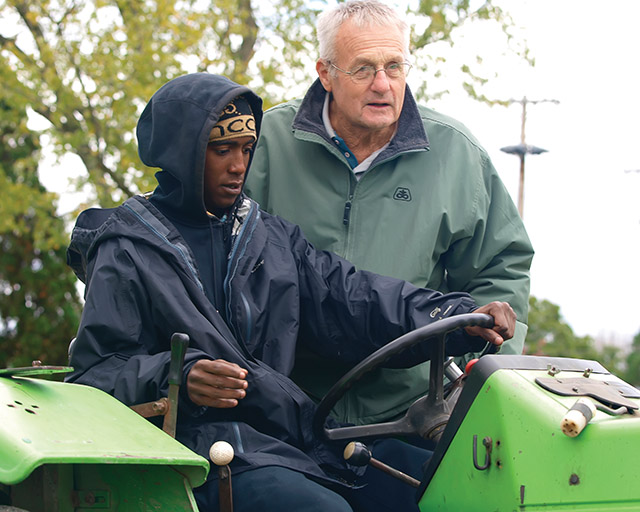 Vision 2020 Schuck Scheiber 5 Rural religious take to the highways and byways Brother Nick Renner, C.PP.S. with a young man from Chicago who is learning to use a tractor.