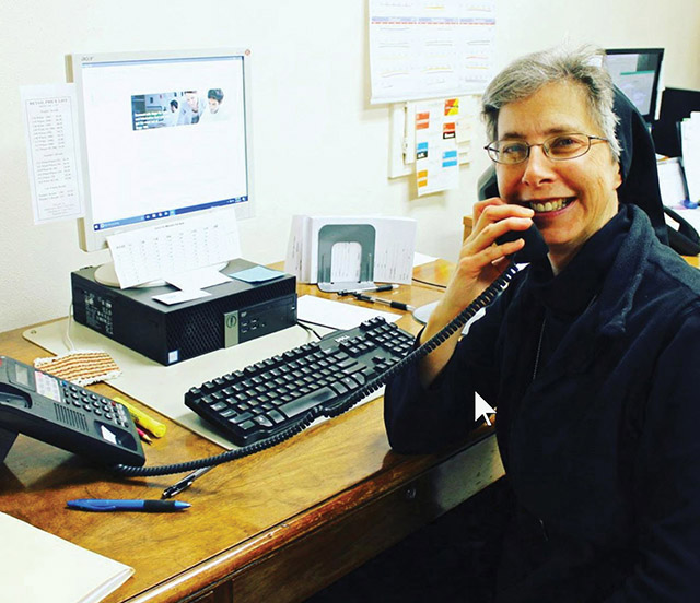 Vision 2021 Cutaia 4 Benedictines believe in balance Sister Ruth Starman, O.S.B. takes a moment from her work for a smile.