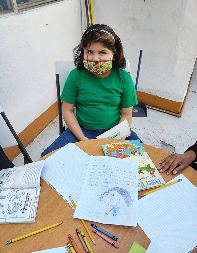Vision 2022 Long 3 Sister Maggie has a mission Samantha Arias Gorotreta shows off the illustrated book report that she’s entering into a reading competition.