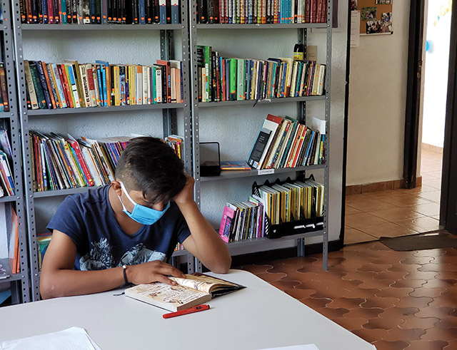 Vision 2022 Long 4 Sister Maggie has a mission Pablo Sanchez reads in the children’s library.