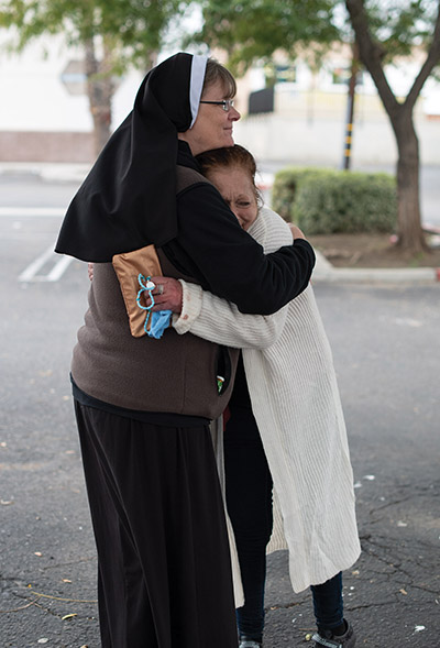 Vision 2023 Mena 2 A charism encourages a caring ministry A Felician sister gives someone a hug.