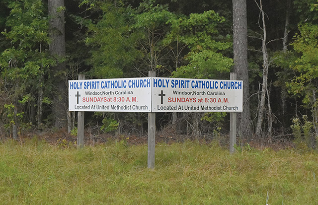 Vision 2023 Feister 2 Ministering to migrants in a carport cathedral Holy Spirit Catholic Church sign