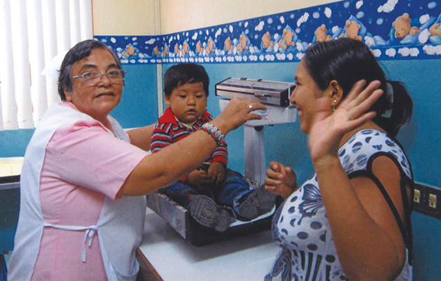 Vision 2024 Spotlight 10 Religious communities have deep and diverse roots Sister Reina Lastenia, O.S.F. weighs a child at a clinic in Peru.