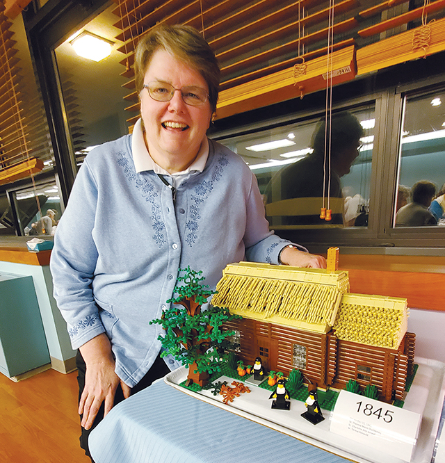 Vision 2024 Spotlight 15 Religious communities have deep and diverse roots Sister Elizabeth A. DeMerchant, I.H.M. displays a log cabin scene made of Legos, which she created to show the early history of her religious community.