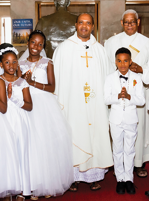 Vision 2024 Masterton 3 Man with a mission Munishi with a First Communion group at St. Edward Parish in Baltimore.