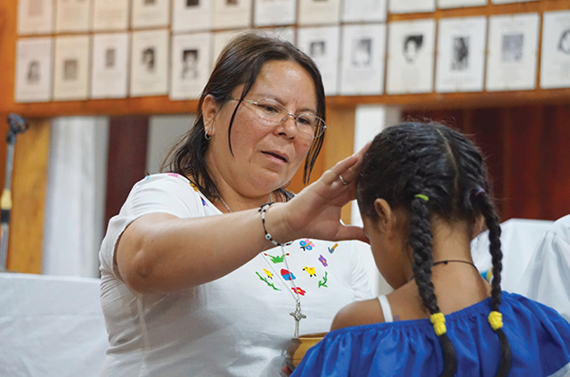 Vision 2025 Pehanich 4 Sister Vilma’s fearless faith Sister Vilma Franco, S.P. blesses a girl during a Communion service.