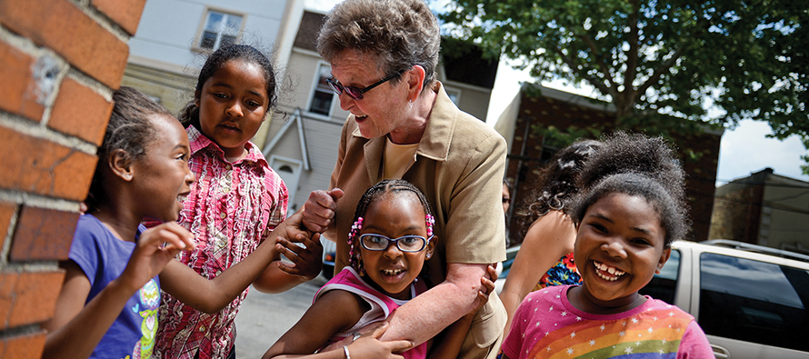 Sister Tesa Fitzgerald, C.S.J. talks to kids from Hour Children foster care home