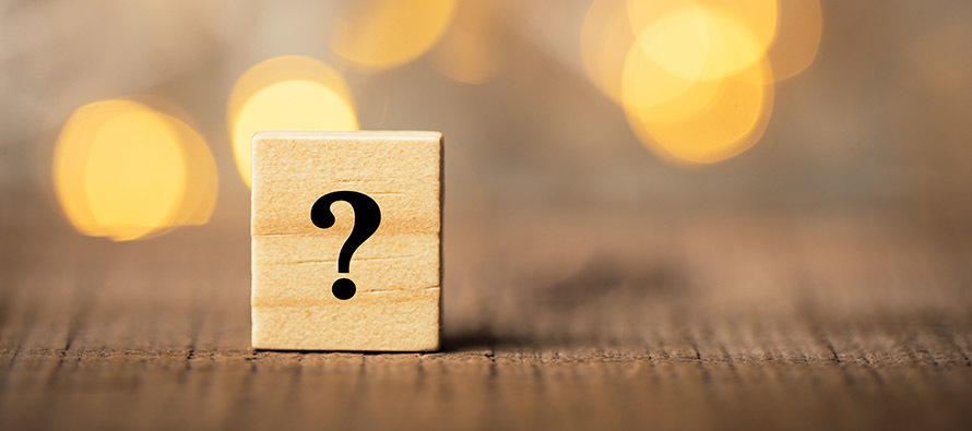 Question mark on a wooden block