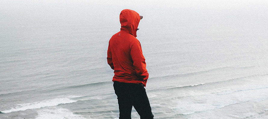 Man looks pensively out at a body of water